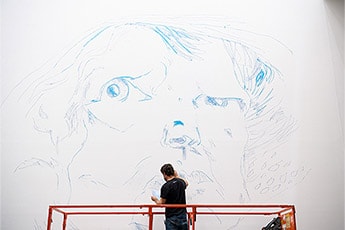 Ben Quilty installing the exhibition at GOMA. Quilty’s mural-size renditions of the sketches he drew for his Archibald Prize-winning portrait of friend and mentor Margaret Olley took over GOMA’s Long Gallery