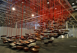 Chiharu Shiota, Japan b.1972 / Accumulation - Searching for the Destination 2014/2019 / Suitcase, motor and red rope